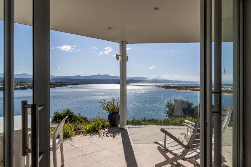 a porch with chairs and a view of the water at No1 Sangaree in Plettenberg Bay