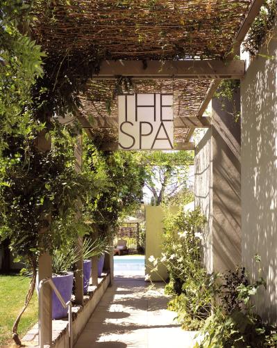 a garden walkway with a sign that reads spa at Hotel Healdsburg in Healdsburg