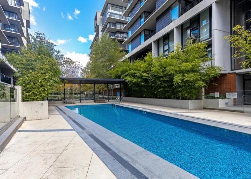a swimming pool in the middle of a building at Cozy 2B apartment in Belconnen GYM POOL in Belconnen