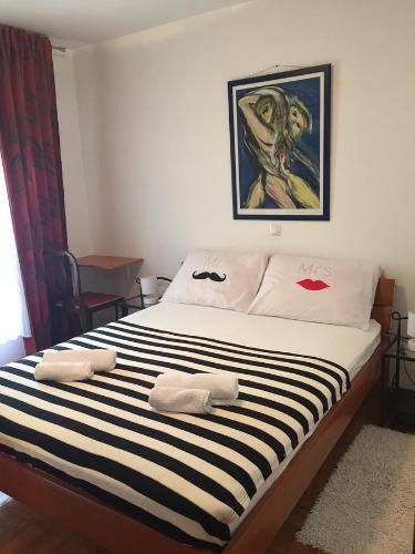 a bedroom with a bed with black and white stripes at Apartment 4 you in Split