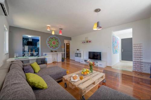 a living room with a couch and a table at Luxury Apartment with Private Heated Pool in Šibenik