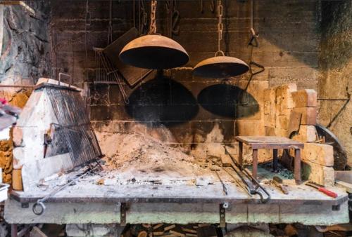 a kitchen with pots and pans hanging from a wall at Luxury Apartment with Private Heated Pool in Šibenik