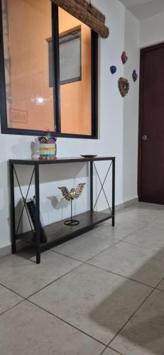 a table in a room with a mirror on the wall at Departamento Casa Oaxaca SMA Pool Rooftgarden in San Miguel de Allende