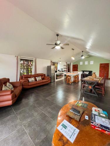 a living room with a couch and a table at Casa Miel Dulce Escapada en el Paraíso in Puerto Jiménez