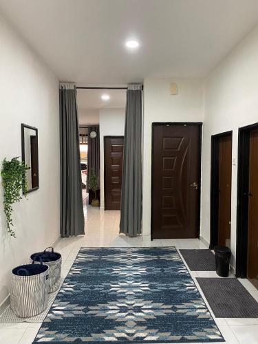 a hallway with two brown doors and a rug at Villa Amani Homestay in Sungai Petani
