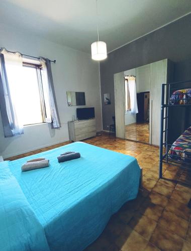 a bedroom with a blue bed with two towels on it at A casa di Irene in Le Marmore