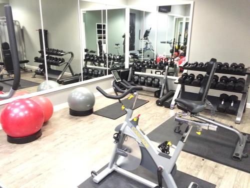 a gym with exercise equipment and a mirror at Hotel Deco in Omaha