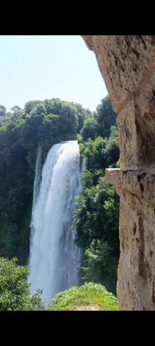 a view of a waterfall from a stone wall at A casa di Irene in Le Marmore