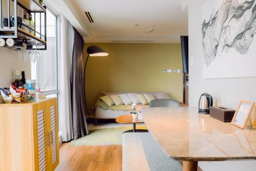 a living room with a bed and a table in a room at The Residences at Novotel Tower in Manila