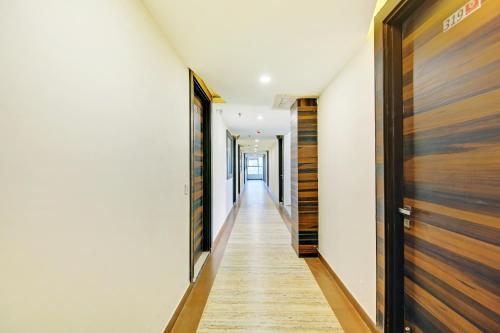 a hallway of a house with wooden doors at Hotel O Kinsfolk Inn in Ghaziabad