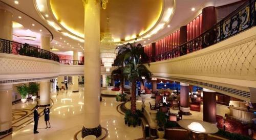 a large shopping mall with people walking in it at New Century Hotel Taizhou 