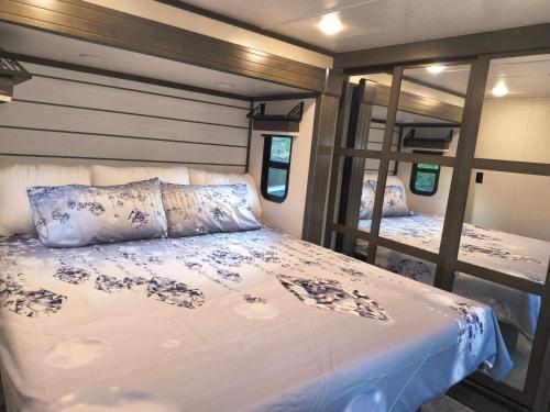 a bedroom with a bed and a mirror at Luxury Glamping in the Mile High - Private pool, Hot Tub, and Outdoor Fire Pit!! in Westminster