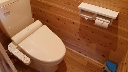 a bathroom with a toilet with a remote control at Minnsyuku Yakushimaya in Yakushima
