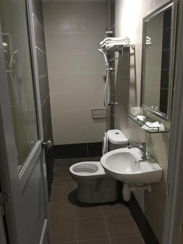 a bathroom with a toilet and a sink at Soho Hotel Semenyih in Semenyih
