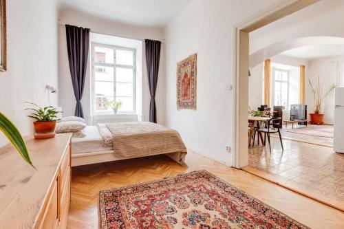 a bedroom with two beds and a living room at Old Town Magical Stay Comfy 2BDR Historic House in Prague