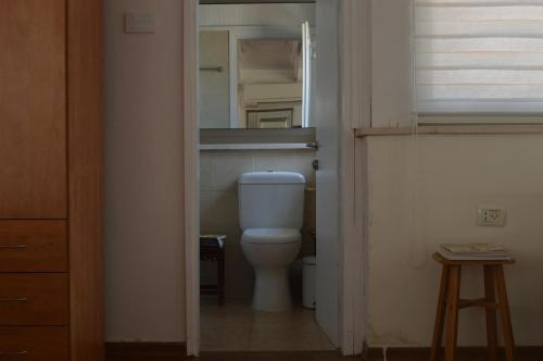 a bathroom with a toilet in a small room at Halal La Nof in Migdal