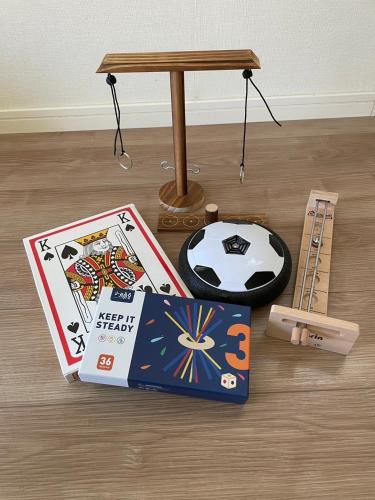 a table with a playing cards and a table with a table at Villa NIRAI in Uruma