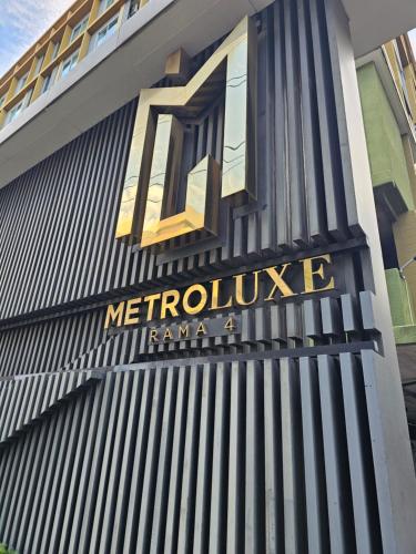a sign on the side of a building at Metroluxe rama4 , city center in Bangkok