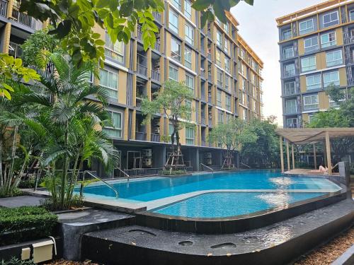 a large swimming pool in front of a building at Metroluxe rama4 , city center in Bangkok