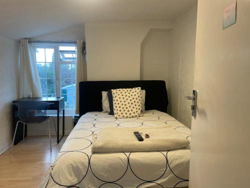 a bedroom with a bed and a desk in it at 96TR Double bed bedroom - Edmonton green in Edmonton