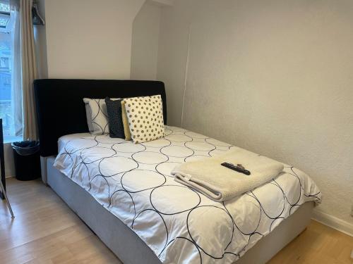 a small bed with a suitcase on it in a room at 96TR Double bed bedroom - Edmonton green in Edmonton