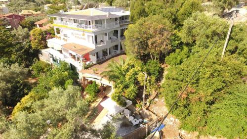 an overhead view of a large white house with trees at Hotel Pegasos in Nikiana