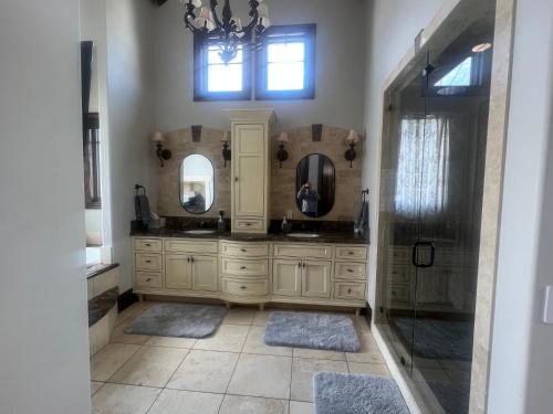 a bathroom with two sinks and two mirrors at ski and summer paradise in Park City