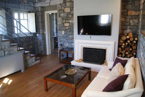 a living room with a couch and a fireplace at The Arcadian in Vytina