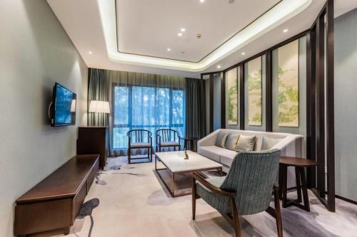a living room with a couch and a table at International Conference Hotel Nanjing in Nanjing
