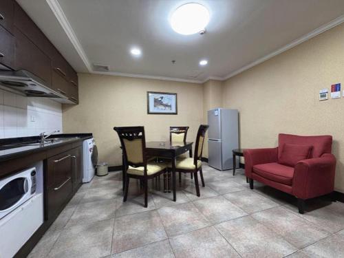 a kitchen with a table and chairs in a kitchen at Changchun Zhuozhan Days Hotel in Changchun