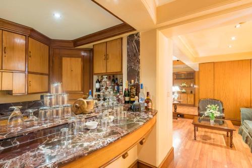 a kitchen with a bar with glasses on it at Hotel Parle International in Mumbai