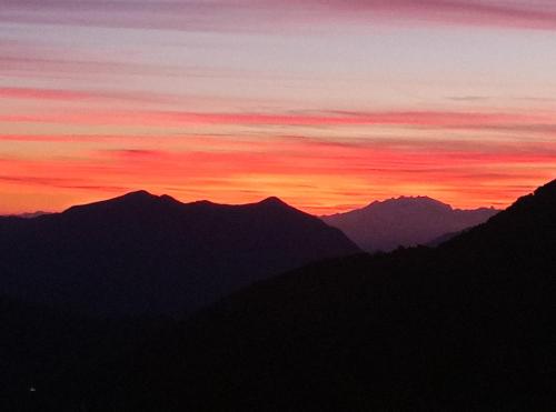 a sunset with mountains in the background at Appartamento nonna Piera in Casargo
