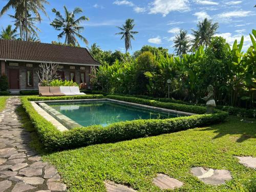 a swimming pool in the yard of a house at Ayuna Family Ubud in Ubud