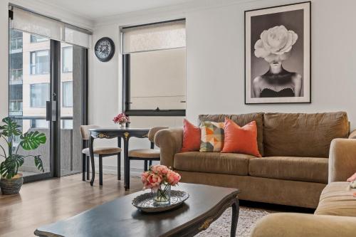 a living room with a couch and a table at Sydney Harbourside Gem in Sydney