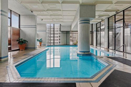 a large pool with blue water in a building at Sydney Harbourside Gem in Sydney
