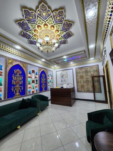 a living room with a couch and a chandelier at People Tours Bukhara in Muruntau