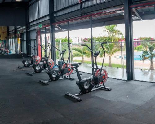 a row of exercise bikes parked in a gym at Luxury 2-Bedroom Modern Apartment in Tatu City