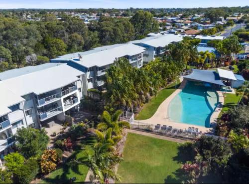 an aerial view of a large building with a swimming pool at Large Pool Newly Renovated Apartment Walk to Whale watching and beaches in Urangan