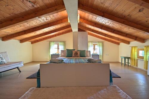 a bedroom with a bed in a room with wooden ceilings at Villa Angela e Giovanni in Vižinada
