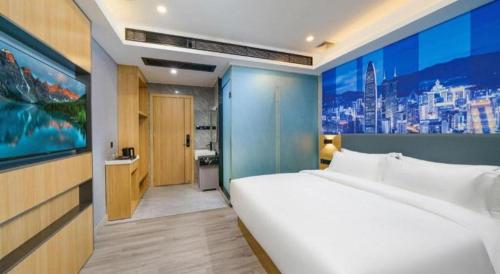 Cama o camas de una habitación en Sheng Lin Na Hotel Minzhi Branch