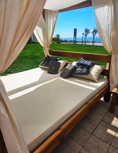 a bed with two pillows sitting on top of it at Residence Hill Lux in Kopaonik