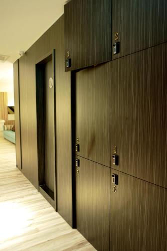 a row of wooden lockers in a room at Poshpacker Hotel in Taipei