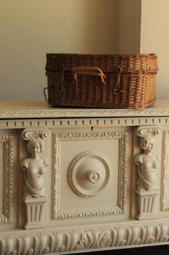 two statues on a shelf with a basket on top at LA CUCCAGNA DI DON BOSCO - No landlords and neighbours - Absolute privacy! in Montafia