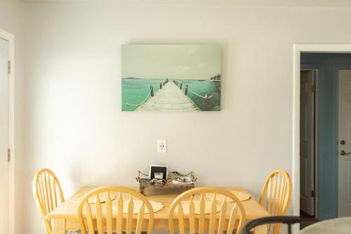 a dining room table with a picture of a pier at Pet Friendly 6 Guest Stay w Yard in Billings
