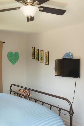 a bedroom with a bed and a tv on the wall at Pet Friendly 6 Guest Stay w Yard in Billings
