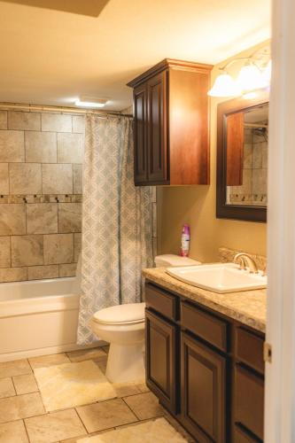a bathroom with a sink and a toilet and a tub at Pet Friendly 6 Guest Stay w Yard in Billings