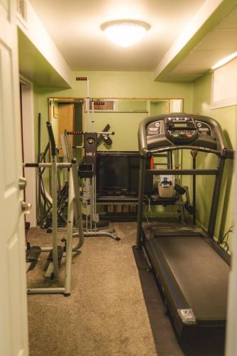 a room with a gym with a treadmill at Pet Friendly 6 Guest Stay w Yard in Billings