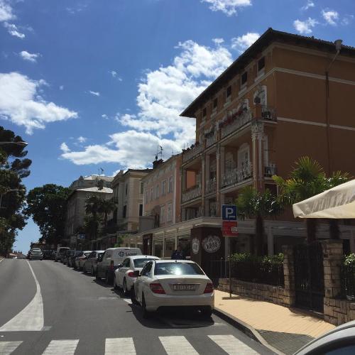 a street with cars parked on the side of the road at Apartment Abbazia in Opatija