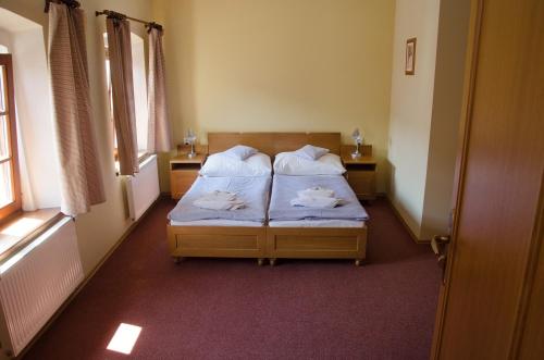 a bedroom with two beds with towels on them at Penzion Nad Oborou in Hradec Králové