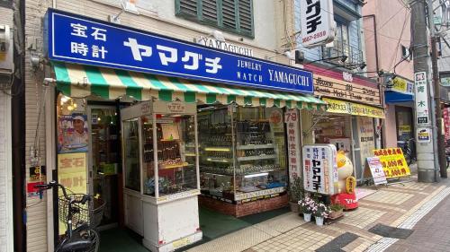 a store on a street in an asian city at THE CAMILLE PLACE Tokyo Edogawa has direct access to Akihabara and Shinjuku, with convenient transportation and free WiFi in Tokyo